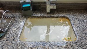 Kitchen sink clogged with grease buildup